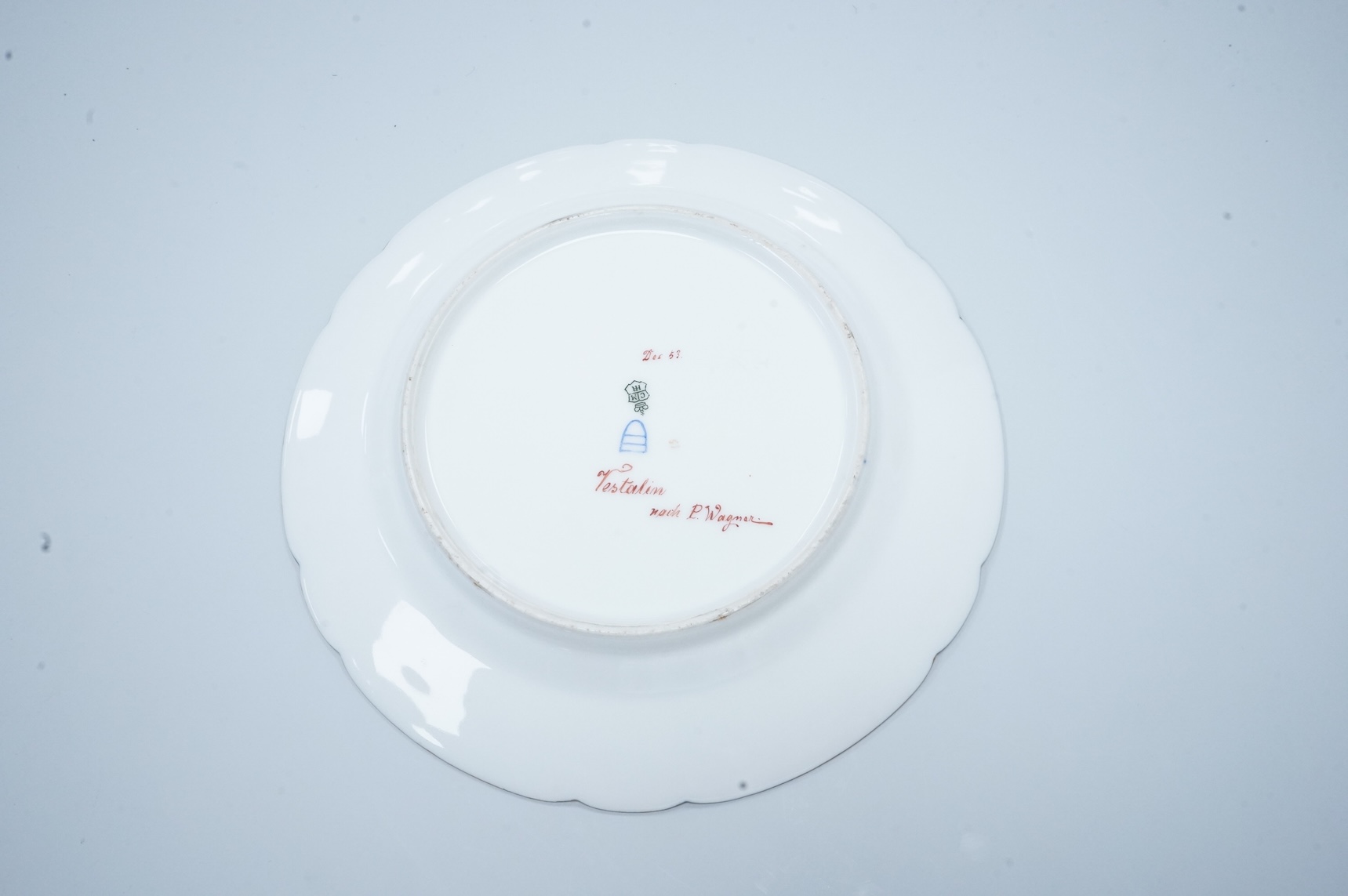 A Vienna-style cabinet plate, painted with a Vestal Virgin, after P. Wagner, depicting a lady feeding pigeons, signed Goget?, 24cm in diameter
